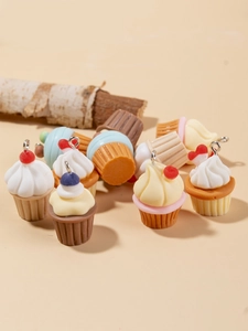 Close-up of colorful resin cupcake charms for DIY jewelry with metal hanging loops