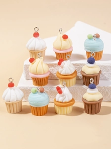 Colorful resin cupcake charms for DIY jewelry making displayed on a stone platform