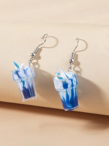 Close-up of cute mini ice cream sundae earrings with blue and white swirl resin details
