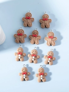 Macro detail of assorted DIY gingerbread man charms with bowties on light blue background