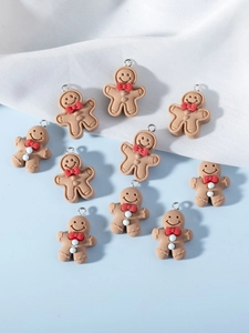 Flat lay of gingerbread man charms with red bows for DIY jewelry and crafts