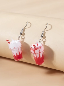 Macro view of cute strawberry sundae earrings with detailed resin cream and striped straw