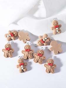 Close-up of cute resin gingerbread man charms with red bow ties for DIY jewelry making