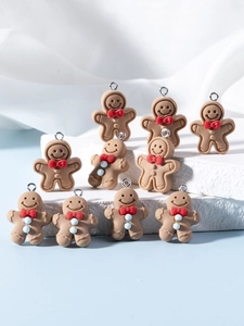 Macro detail of gingerbread man resin charms with red bows and silver metal rings