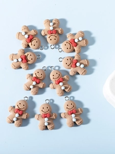 Detailed view of ten resin gingerbread man charms for DIY jewelry and necklaces
