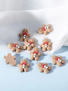 Macro detail of resin gingerbread man charms with red bow ties and silver loops