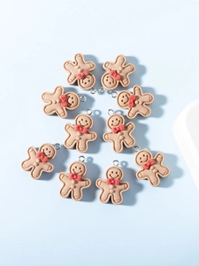 Circle arrangement of ten gingerbread man charms with red bows for DIY jewelry making