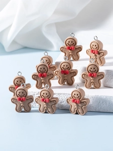Detail of ten cute resin gingerbread man charms with red bows for DIY jewelry making
