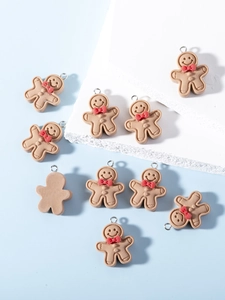 Macro shot of resin gingerbread man charms with red bows and silver metal rings