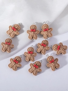 Detailed view of ten cute gingerbread man charms with red bows and silver loops for DIY jewelry