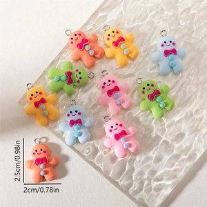 Detail view of colorful resin gingerbread man charms with specific dimensions 2.5cm x 2cm