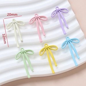 Detailed macro view of DIY colorful bow pendants with dimensions of 20mm by 32mm