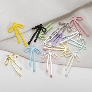 Macro view of macaron colored bow-shaped alloy charms for DIY jewelry making