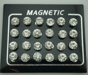 Close-up of 12 pairs of 6mm magnetic stud earrings with round clear rhinestones on a card