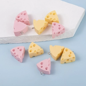 Macro detail of resin triangle cheese charms in pink and yellow with realistic textures