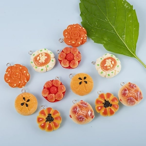 Miniature resin food charms featuring hyper-realistic cakes and cookies for jewelry making