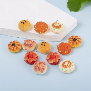 Detailed view of realistic resin miniature cake and pastry charms on stone board