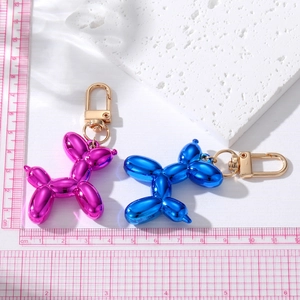 Polished electroplated balloon dog keychains in purple and blue with gold hardware
