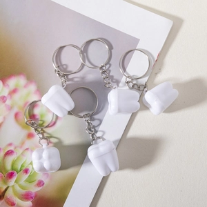 Five-piece set of white tooth-shaped keychains with realistic molar design and metal rings