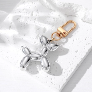 Detail of silver plated resin balloon dog keychain with golden metallic D-ring clasp