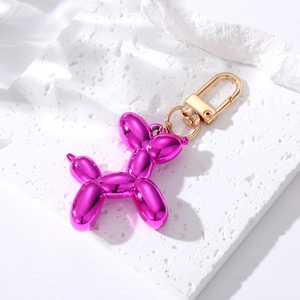 Fashionable metallic magenta balloon dog keychain with elegant gold lobster clasp