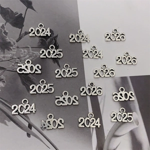 Detailed view of silver alloy year 2025 and 2026 number charms for DIY jewelry making