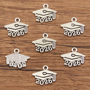 Detailed macro view of silver 2026 graduation cap alloy charms for DIY jewelry making
