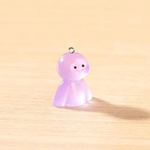 Gros plan d'un porte-clés fantôme en résine violette translucide sur bois naturel