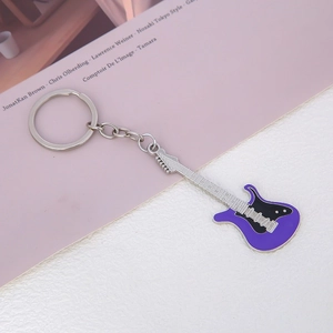 Detailed macro view of a purple electric guitar keychain with silver alloy accents