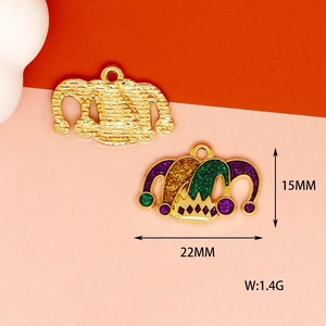 Macro detail of 15x22mm Mardi Gras mask pendant with glitter oil drip and purple green colors