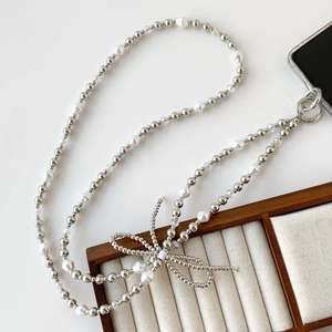 Chic phone lanyard with silver beads, irregular white pearls, and a stylish metal bow