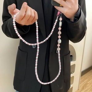 Pink and white long acrylic beaded crossbody strap for phone or bag on black blazer