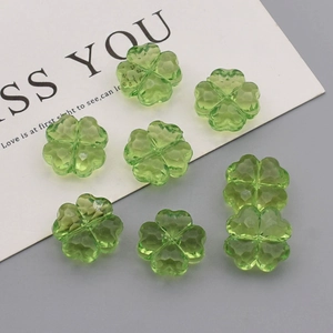 Macro detail of faceted green acrylic clover beads for DIY jewelry making crafts
