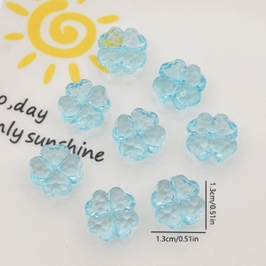 Macro shot of 1.3cm light blue translucent clover-shaped acrylic beads with faceted finish