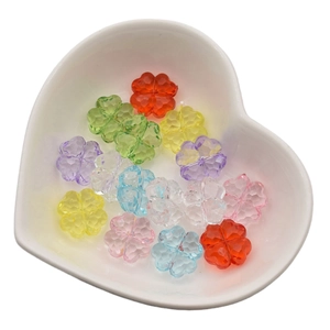 Colorful clover-shaped acrylic beads with faceted finish in heart-shaped white tray