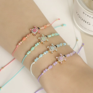 Set of 4 woven turtle bracelets with colorful crystal beads and adjustable cords
