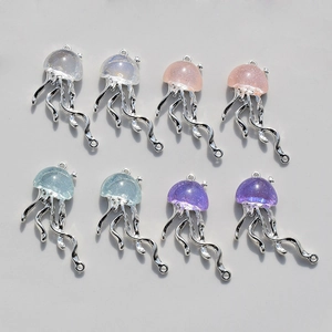 Detailed macro view of jellyfish-shaped alloy pendants with resin glitter in four colors