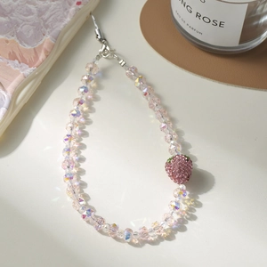 Bijou de téléphone fraise en perles roses irisées avec un pendentif orné de strass