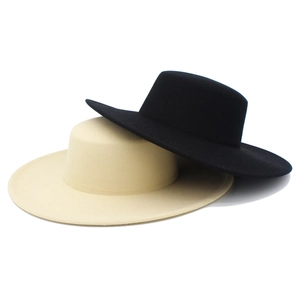 Detail of black and beige wool felt flat top hats with wide brims and vintage style