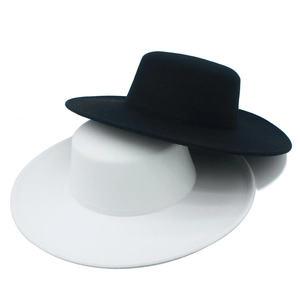 Detail view of black and white boater hats showing premium felt texture and neat stitching
