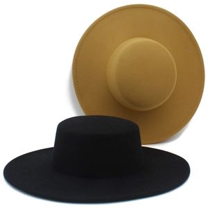 Detail shot of flat top wool felt boater hats in classic black and ginger yellow colors