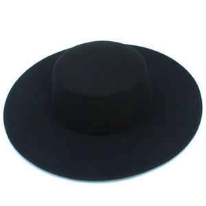 Detailed close-up of a high-quality black wool felt flat top hat with a 10cm wide brim