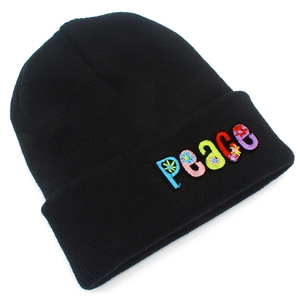 Close-up of vibrant PEACE letter embroidery with floral details on black knitted beanie