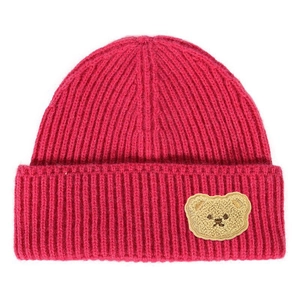 Detailed view of pink ribbed knit beanie with a cute brown plush bear patch