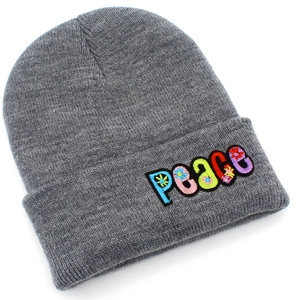 Close-up of gray knit beanie with colorful floral PEACE embroidery on the folded cuff