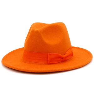 Detail of bright orange wool fedora hat featuring a matching grosgrain ribbon and bow