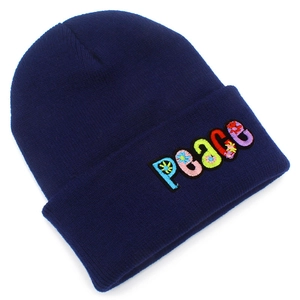 Close-up of multicolor PEACE letter embroidery on navy blue ribbed knit beanie hat