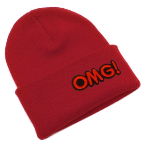Detail of red knit beanie with OMG! orange embroidery patch and soft ribbed texture