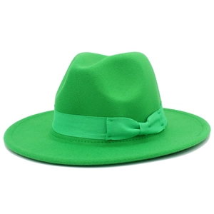 Close-up of a green wool fedora hat featuring a matching ribbon and small bow detail
