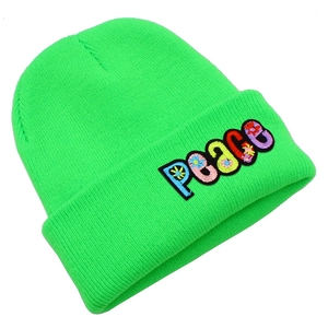 Detailed texture of neon green beanie with colorful Peace letter embroidery and floral detail